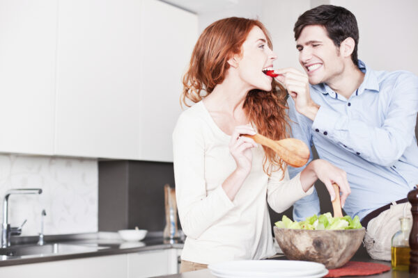 A young couple in their kitchen. She is redheaded and he has brown hair. More images of this lifwstyle series in port, including breakfast time, preparing salad and pasta. Made with professional make-up.